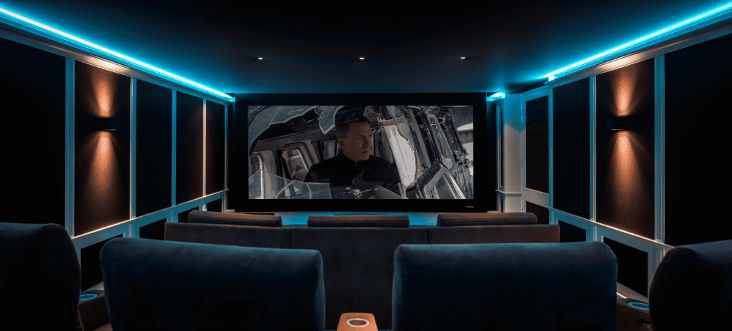Luxe thuisbioscoop met comfortabele stoelen en een groot scherm waarop een filmscène met een man in een cockpit te zien is. Luxe thuisbioscoop met comfortabele stoelen en een groot scherm waarop een filmscène met een man in een cockpit te zien is.